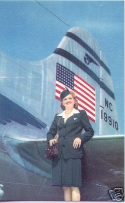 1940s  A Stewardess poses by the tail of aircraft NC19910 A Boeing 307 